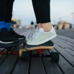 couple wear platform sneakers on skateboard