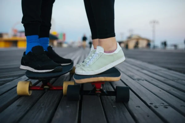 couple wear platform sneakers on skateboard